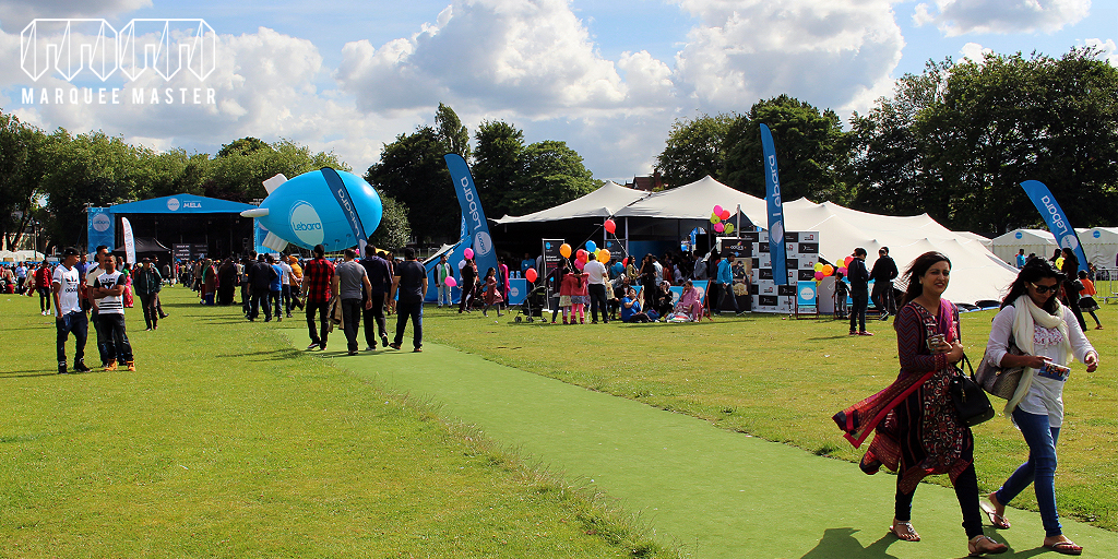 Festival site with white tents and crowds